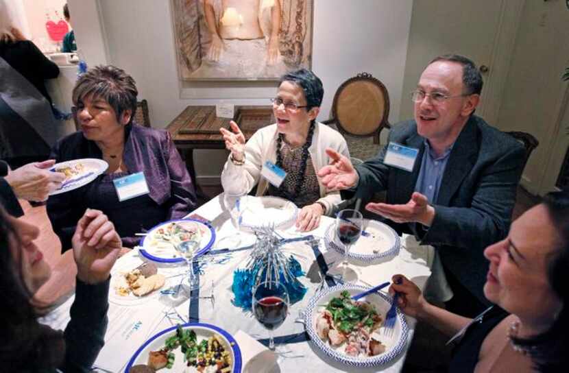 
Debra Liva Lopez (from left), Jackie Wald and Michael Wald chat during their Hanukkah y Las...