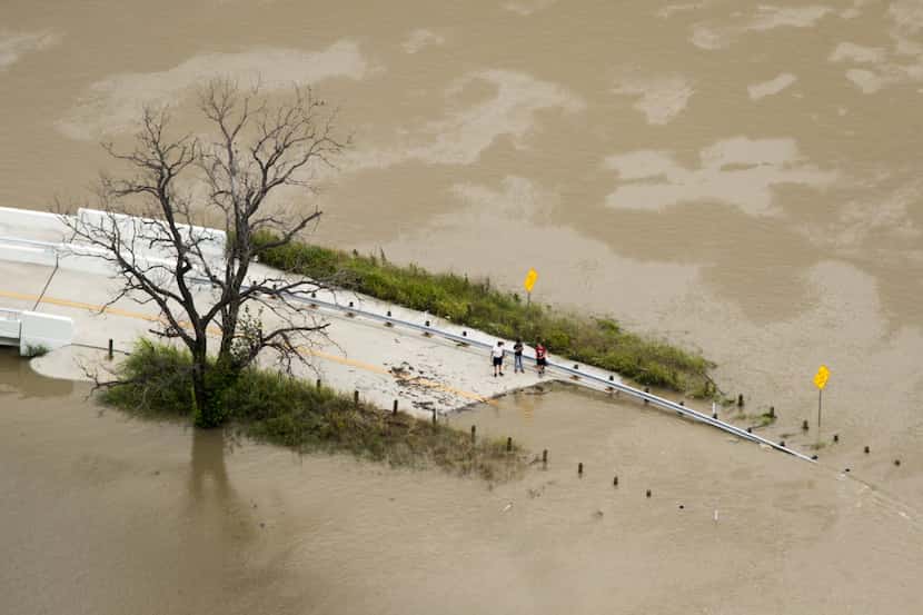  Flood waters from the swollen Trinity River surround a roadway in Dallas. (Smiley N....