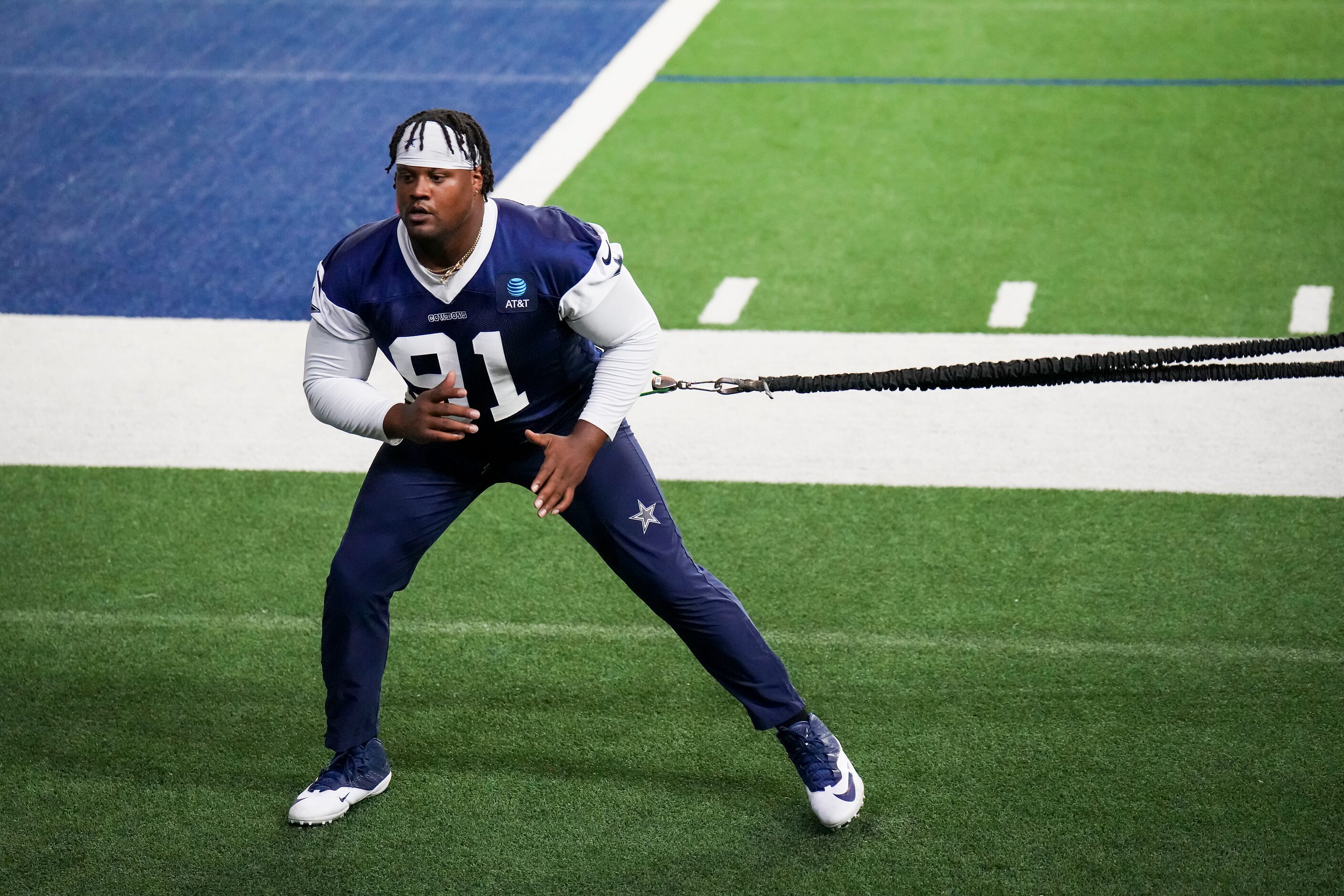 Dallas Cowboys defensive end Carlos Watkins works with a resistance band during the OTA...