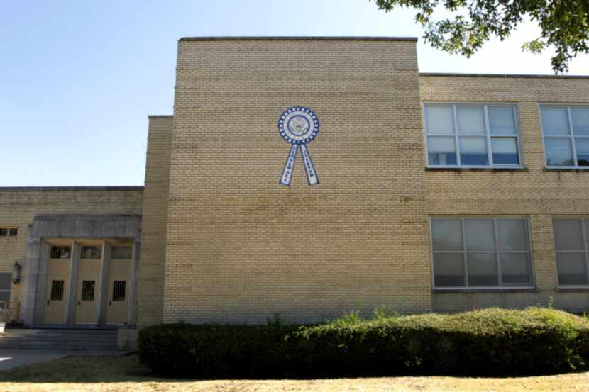 A sign at Stonewall Jackson Elementary touts its 1998-99 designation as a National Blue...