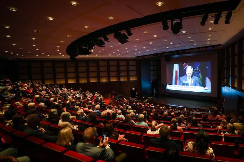 Guests at Saturday evening's documentary screening watch a video of former President George...