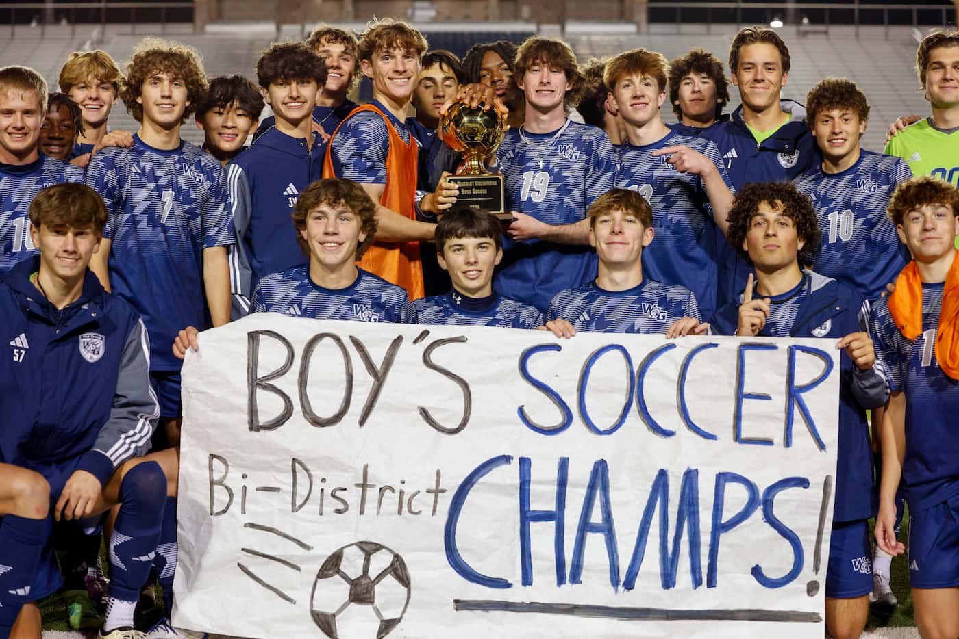 Prosper Walnut Grove players poses with the Bi-district trophy and banner after a UIL Class...