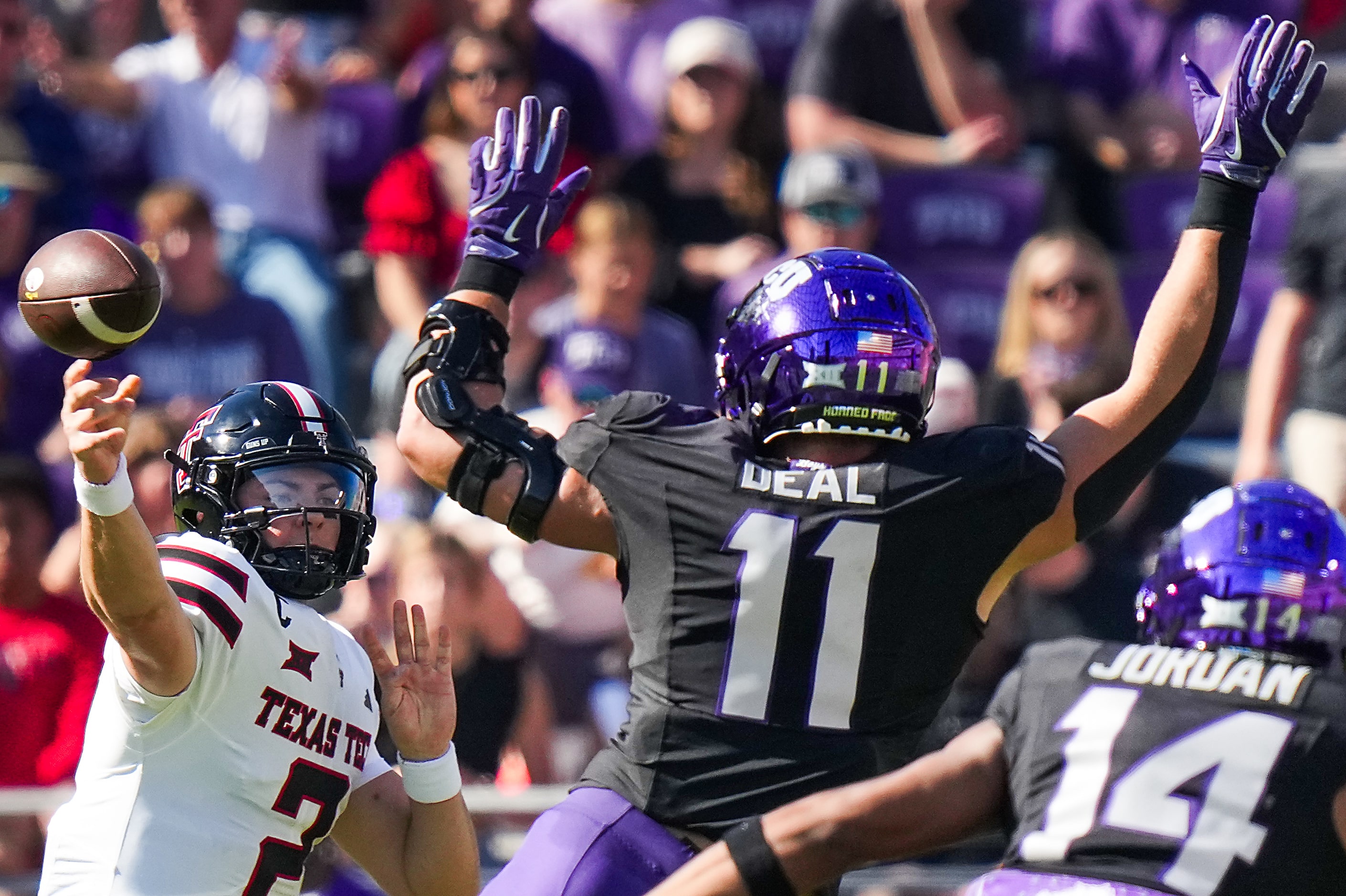 Texas Tech quarterback Behren Morton (2) throws a pass under pressure from TCU linebacker...