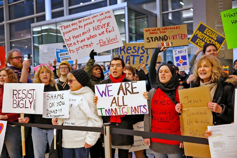 People chant slogans at the Indianapolis International Airport, Sunday, Jan. 29, 2017,...
