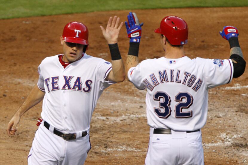Texas Rangers second baseman Ian Kinsler (5) is congratulated by Josh Hamilton after...