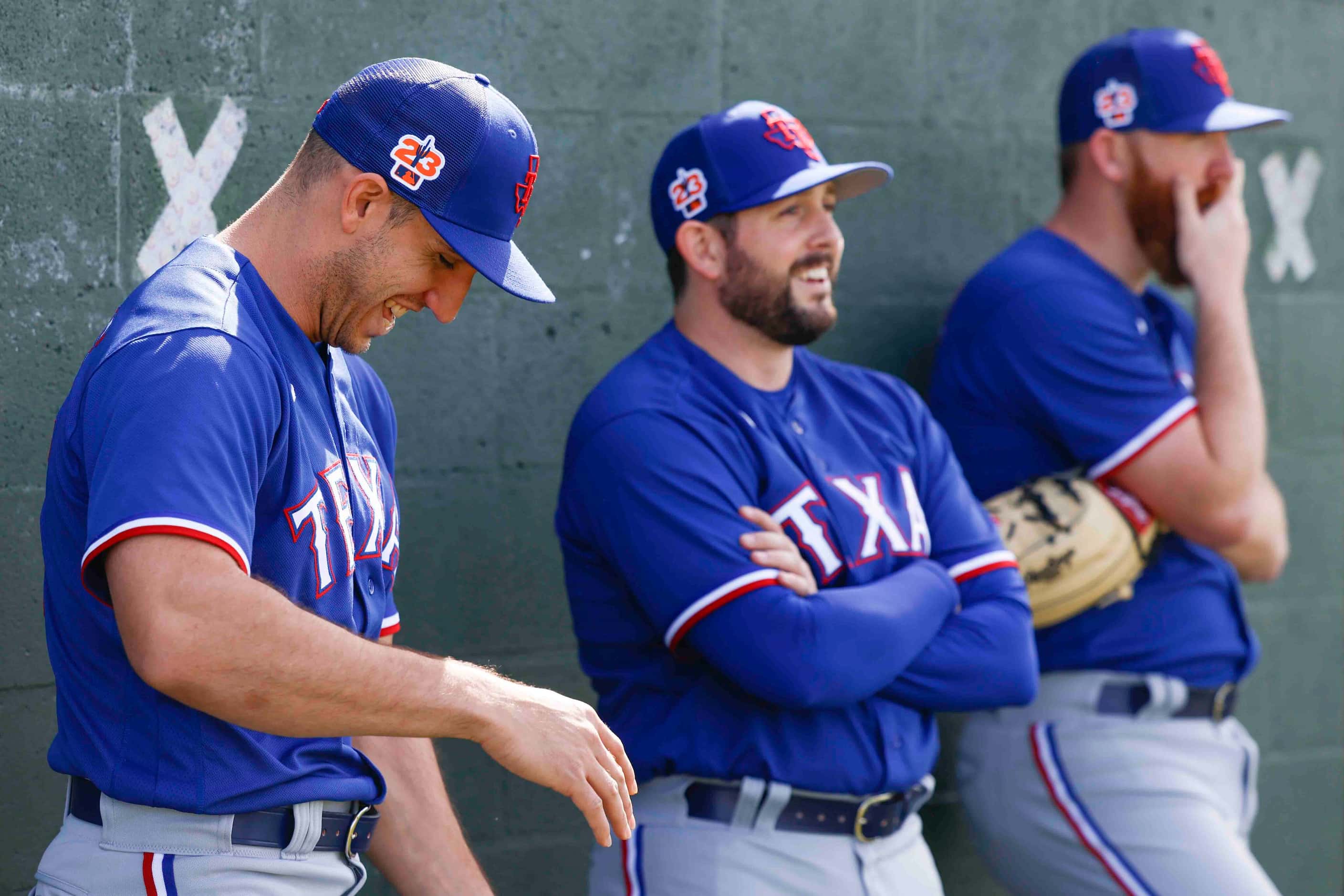 Texas Rangers pitcher Jacob Barnes, left, laughs as he talks to pitcher Dominic Leone,...