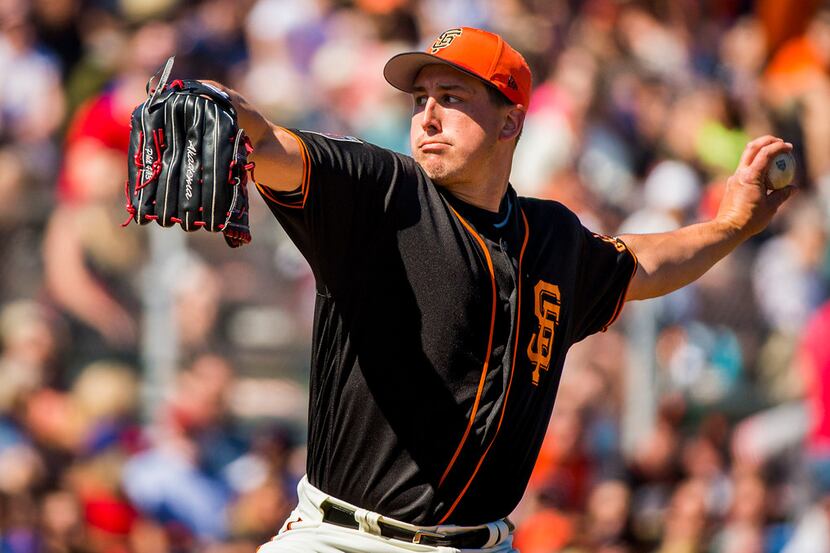 San Francisco Giants pitcher Derek Holland pitches during the third inning of a spring...
