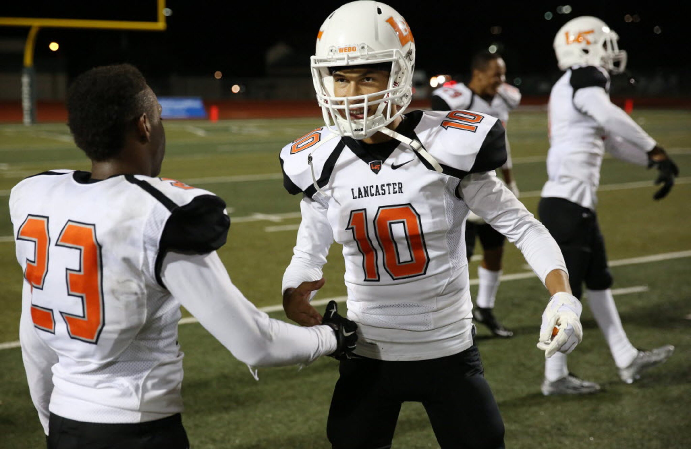 Lancaster defensive back Jaymir Sparrow (23) and quarterback Ryan Ross (10) celebrate...