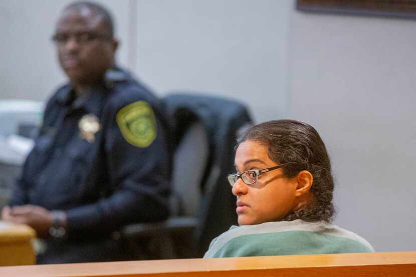 Sini Mathews looks behind her in the courtroom after a bond reduction hearing at the Frank...