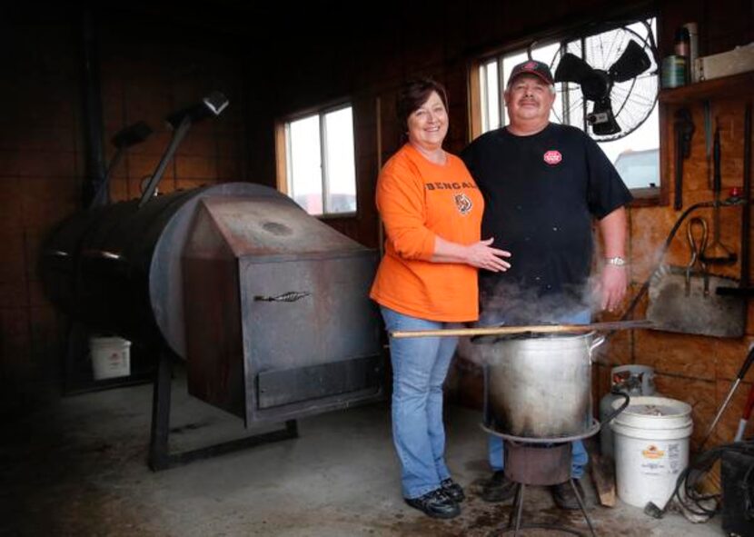 
Pitmaster and owner Steve Graham and his wife Vanessa pose for a photo with his smoker at...