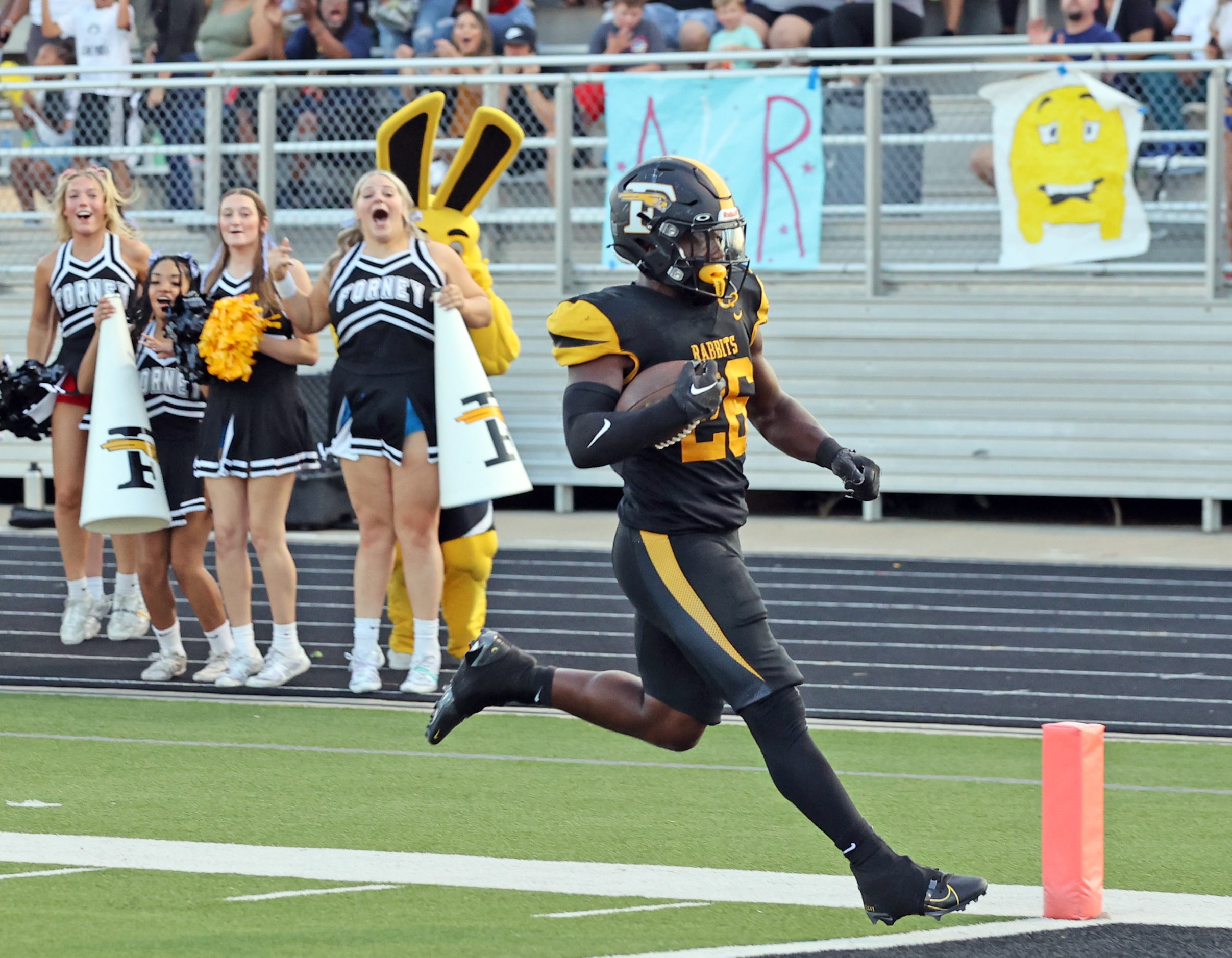 Forney RB Javian Osborne (26) coasts into the end zone for a touchdown, much to the delight...