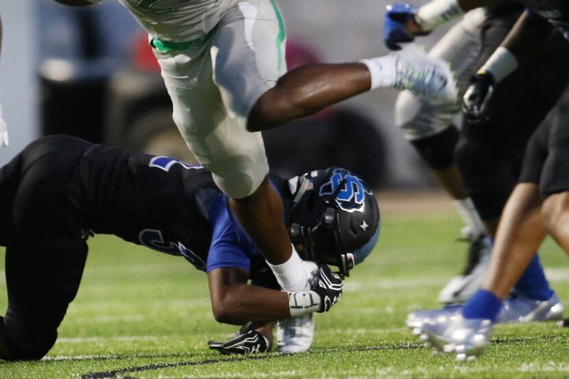 Waxahachie running back Kenedy Snell (2) dances his way into the Mansfield Summit secondary...