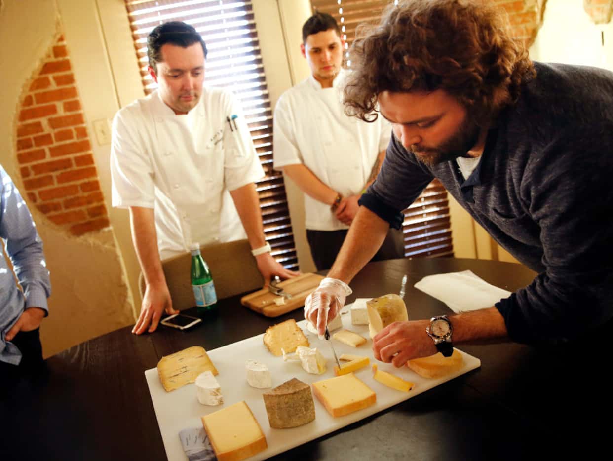 Adolphus Hotel chef Michael Ehlert (left) and sous chef David Gomez (center) watch as...