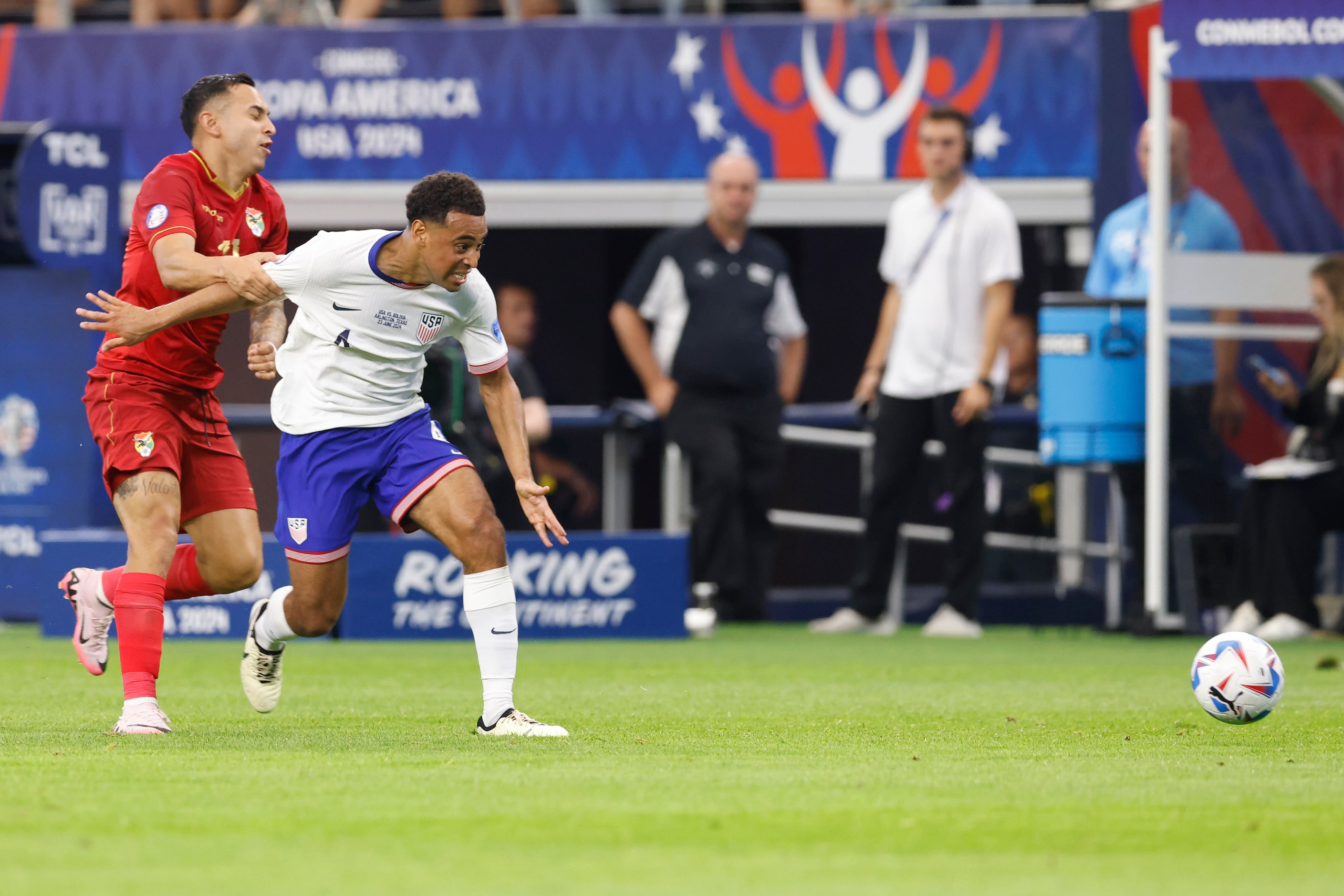 Bolivia forward Bruno Miranda (19) holds United States midfielder Tyler Adams (4) as he...