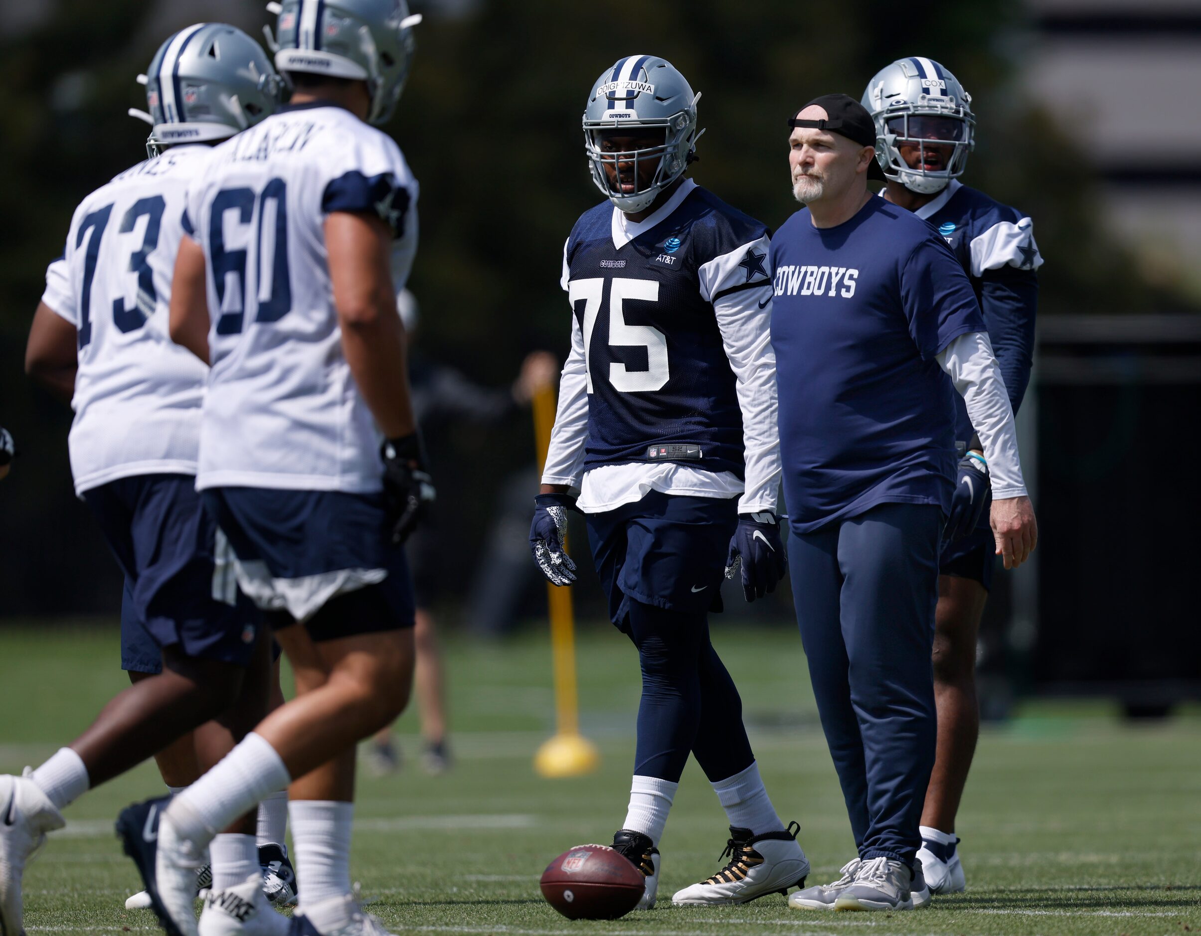 Dallas Cowboys defensive coordinator Dan Quinn (right) fills in at nose tackle when rookie...