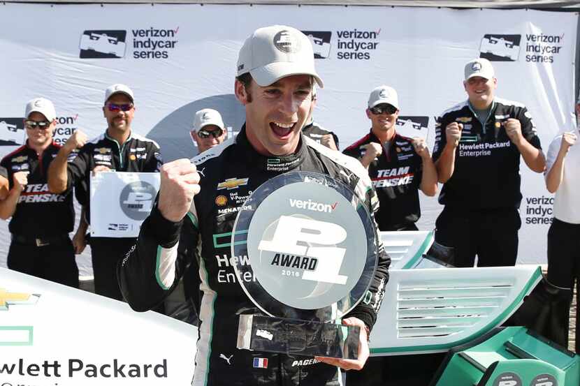 Simon Pagenaud, of France, celebrates after winning the pole position in qualifications for...