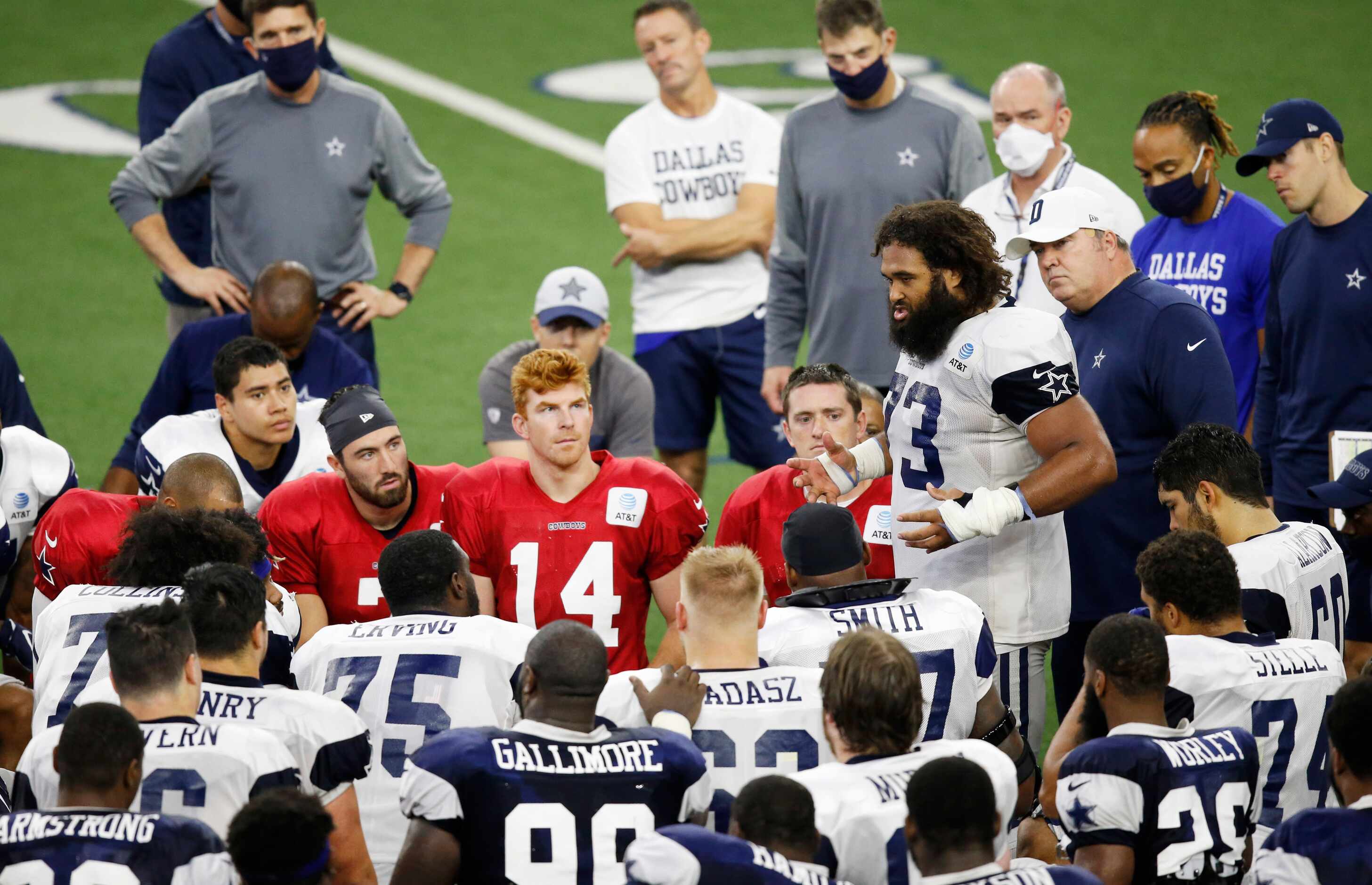 Dallas Cowboys center Joe Looney (73) talks to his teammate shortly after practice during...