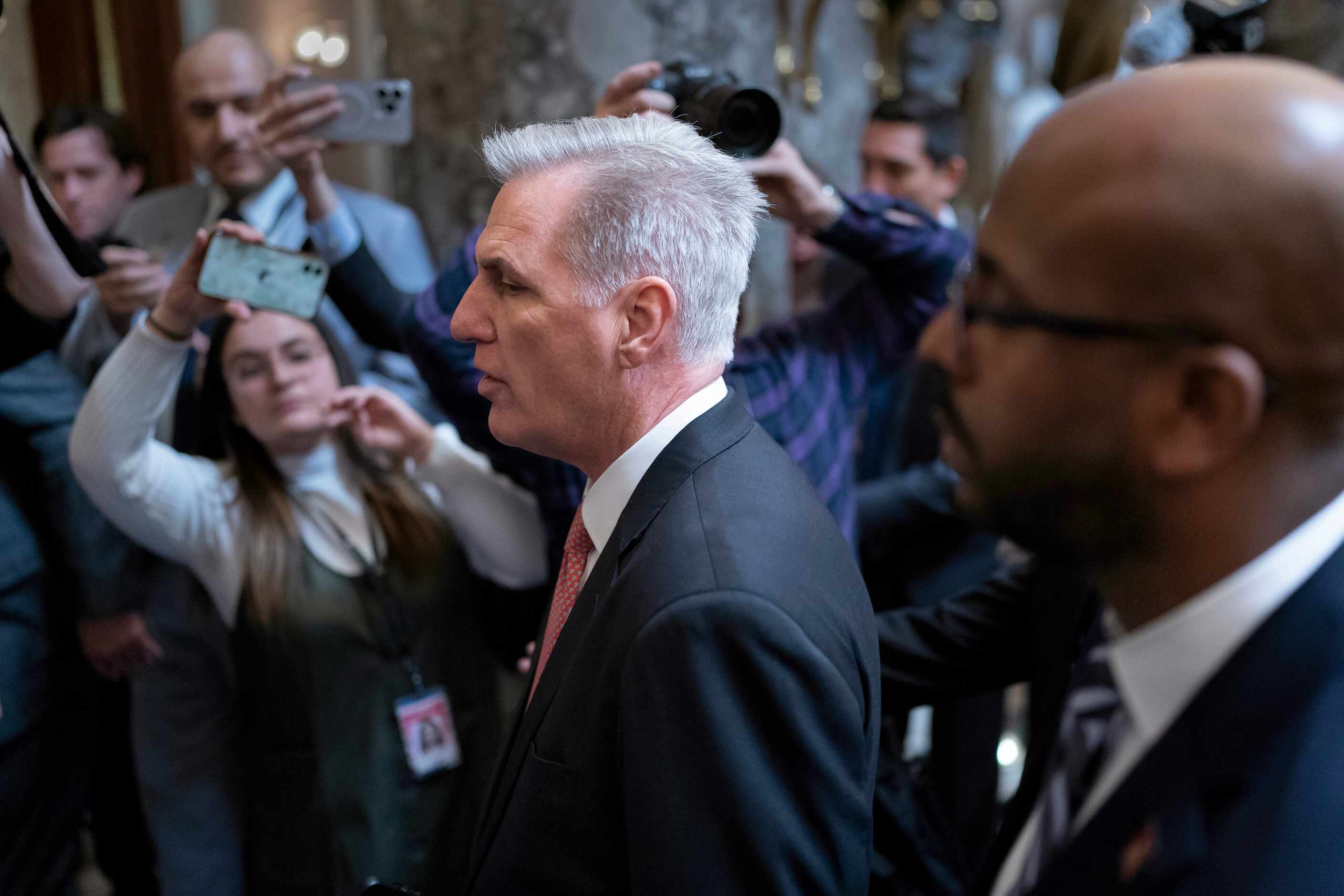 Rep. Kevin McCarthy, R-Calif., walks to the chamber as he struggles with lawmakers in his...