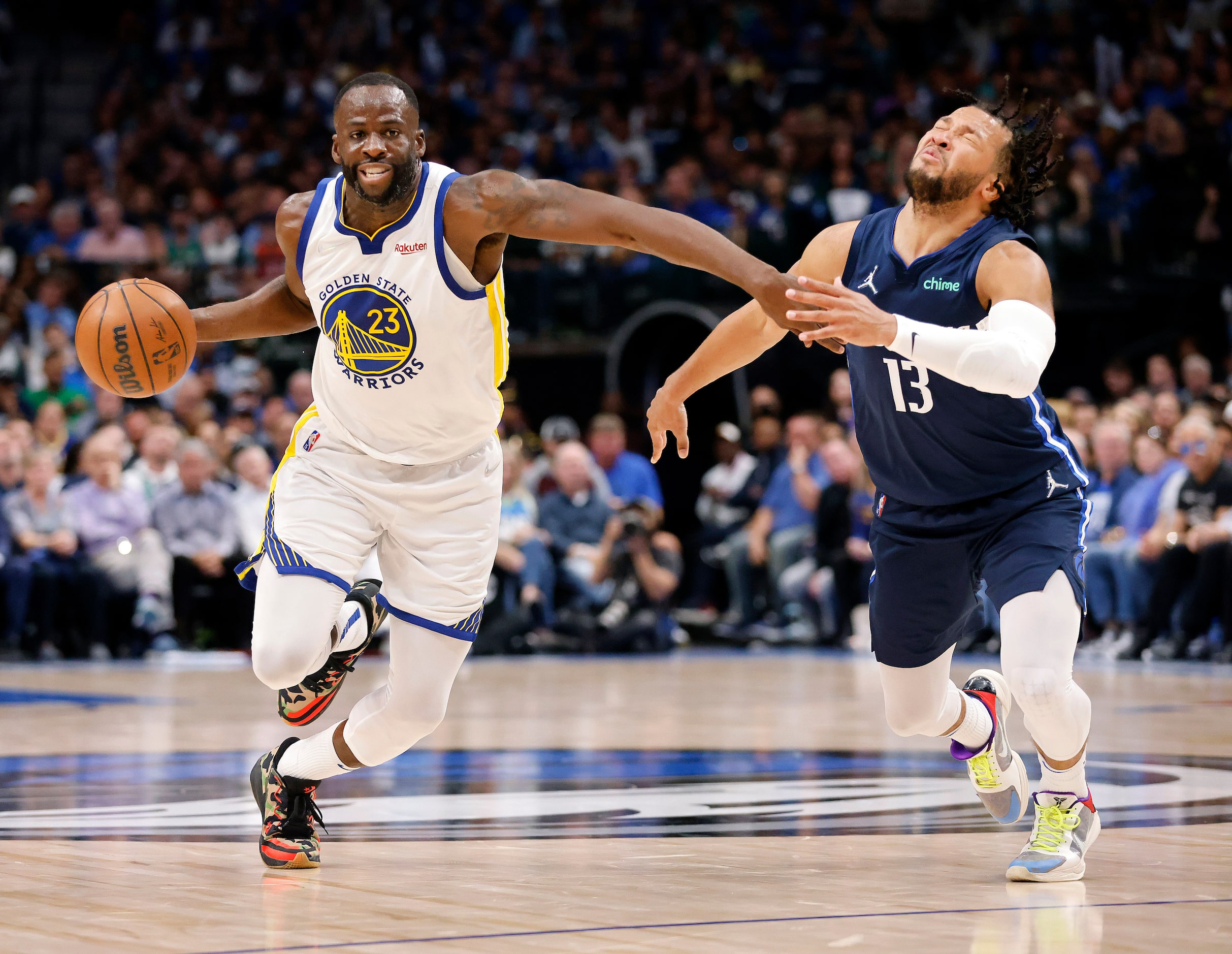 Dallas Mavericks guard Jalen Brunson (13) reacts as he's hit in the face by Golden State...