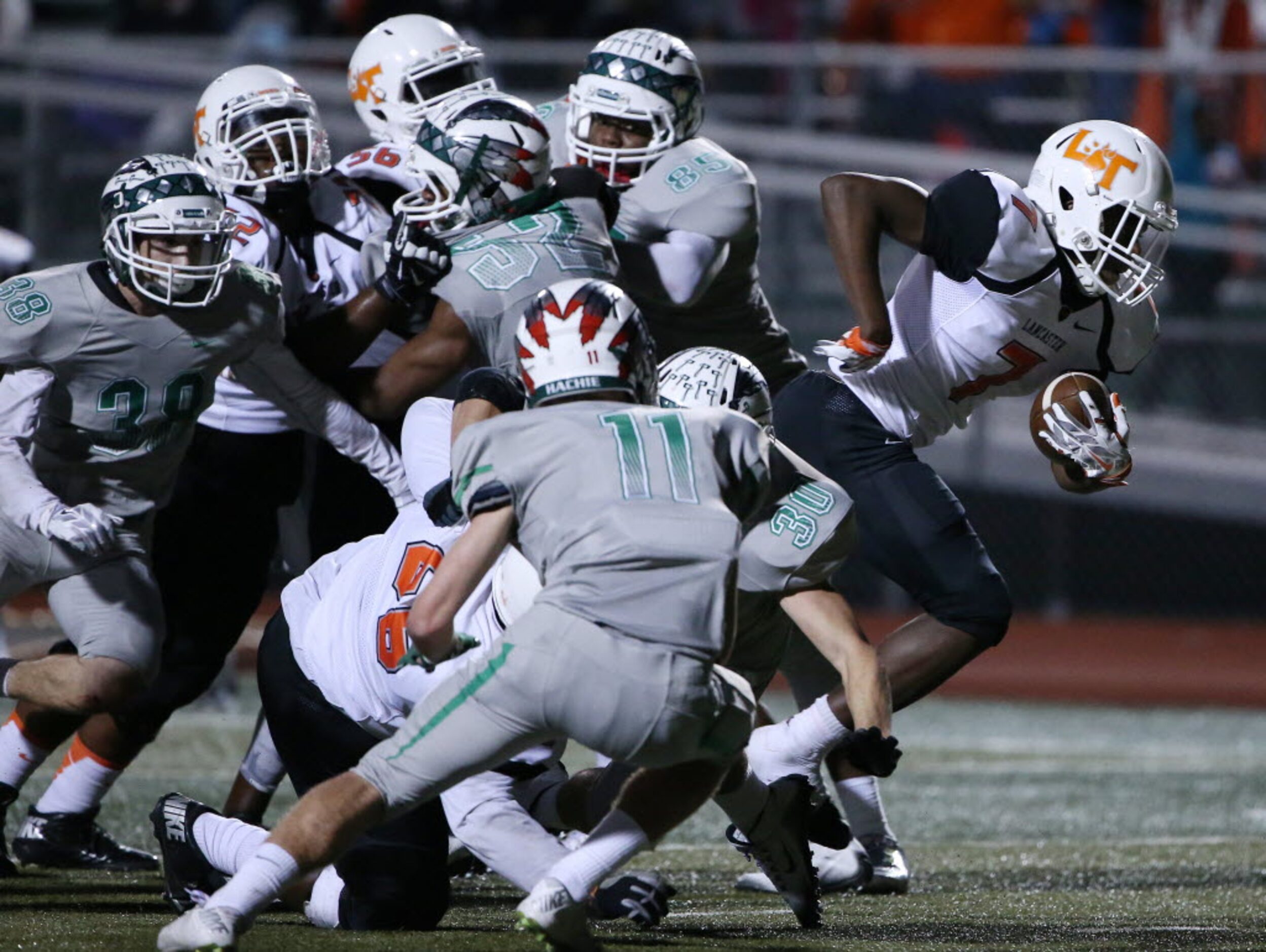 Lancaster running back Spencer Gilbert (7) breaks tackles while rushing for a touchdown to...