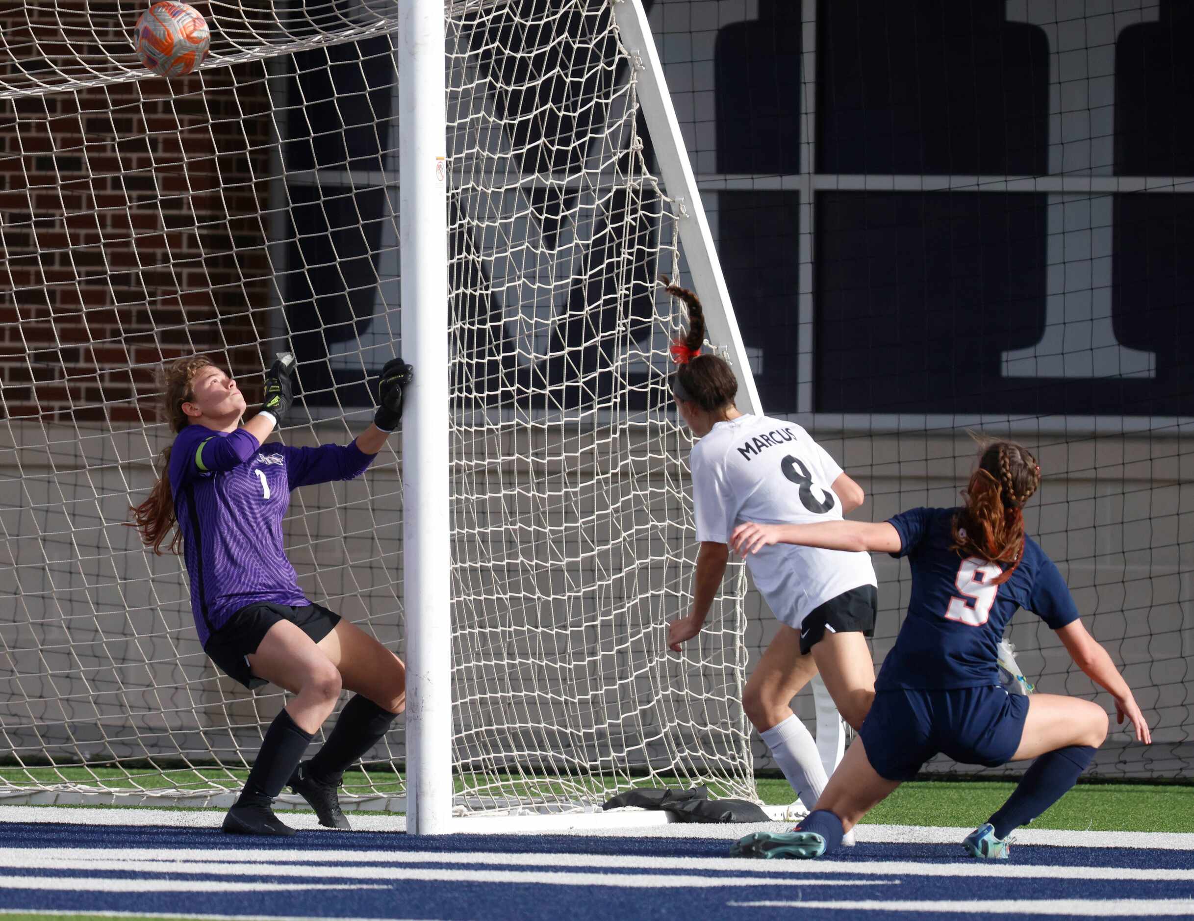 Marcus’ Emma Fioretti (8) scores a goal past Allen’s goalkeeper Robbi Curry (1) during the...
