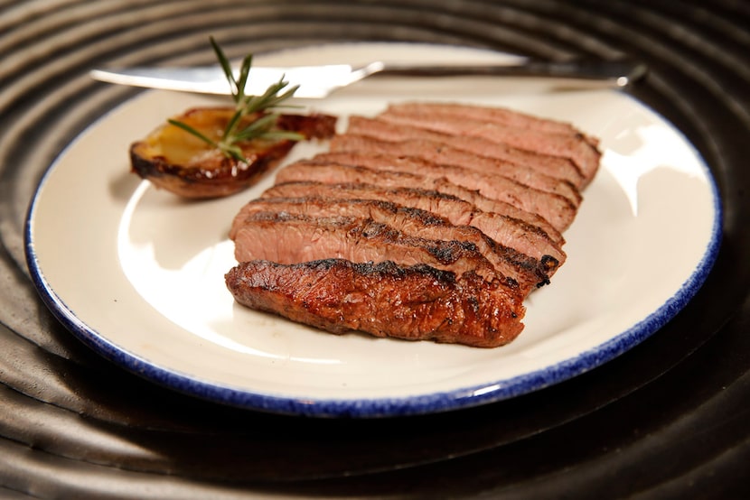 A sous vide flat iron steak prepared on a wood fired-grill at Knife Modern Steakhouse in...