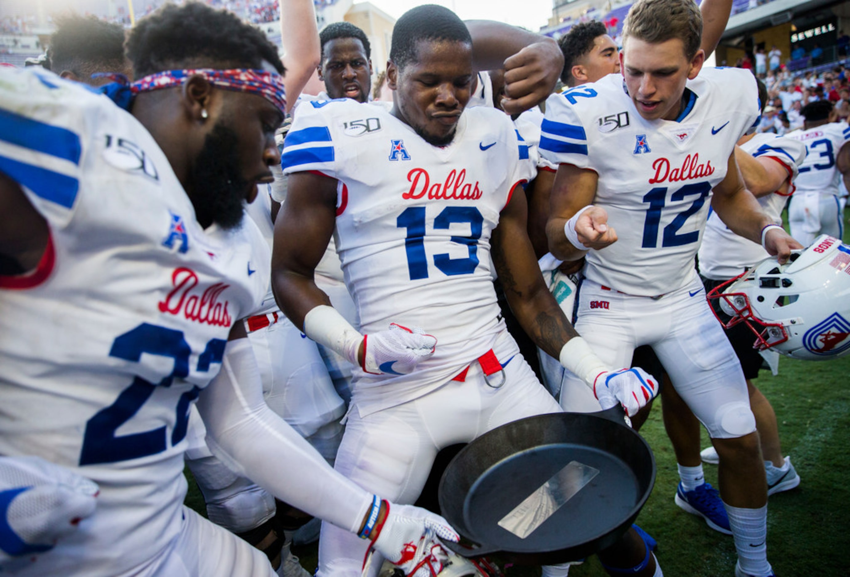 Southern Methodist Mustangs celebrate a 41-38 win over TCU Horned Frogs by hoisting the...