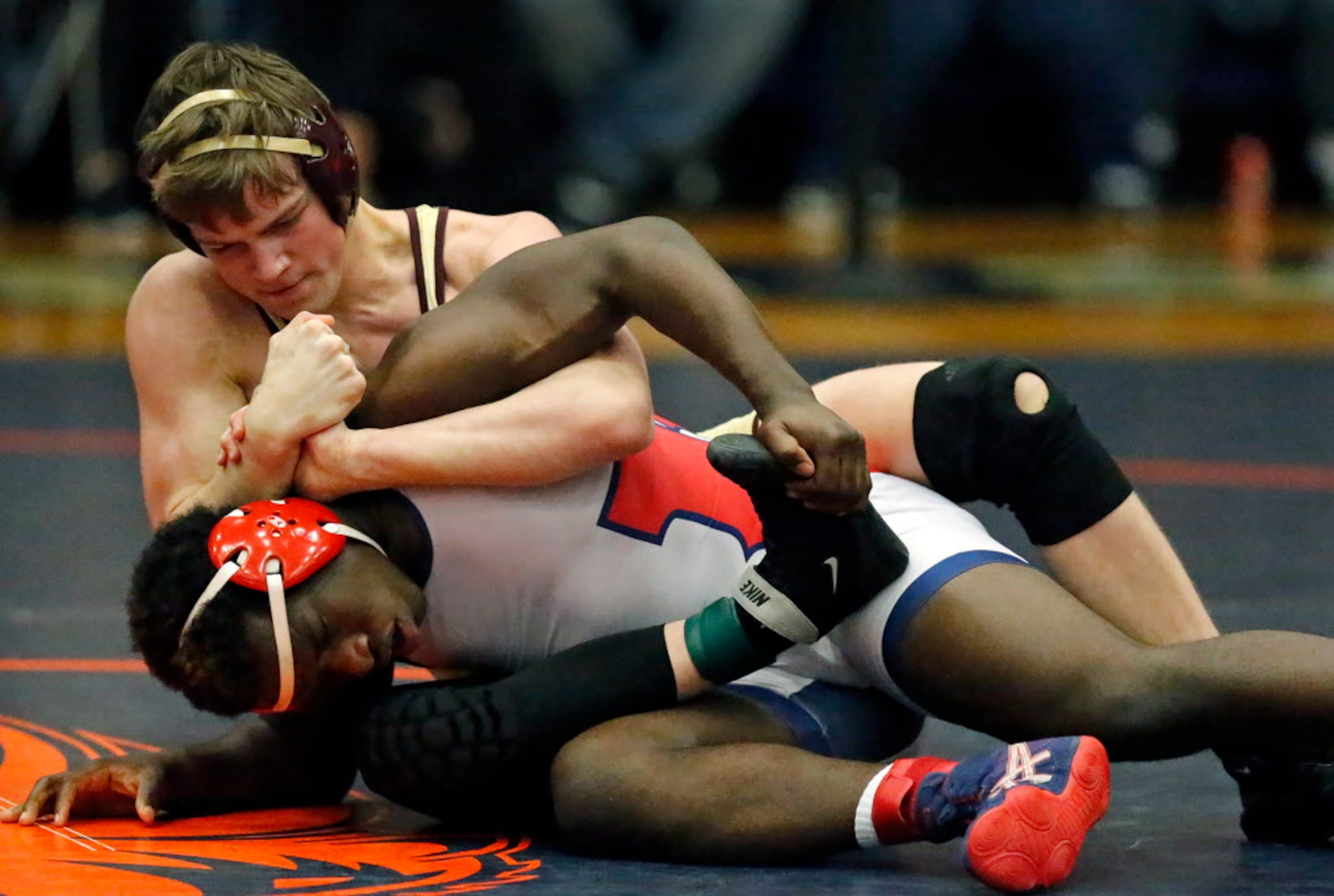 Kurt Lenz (top) of Frisco Heritage High School lost his championship match with Aiden Jean...