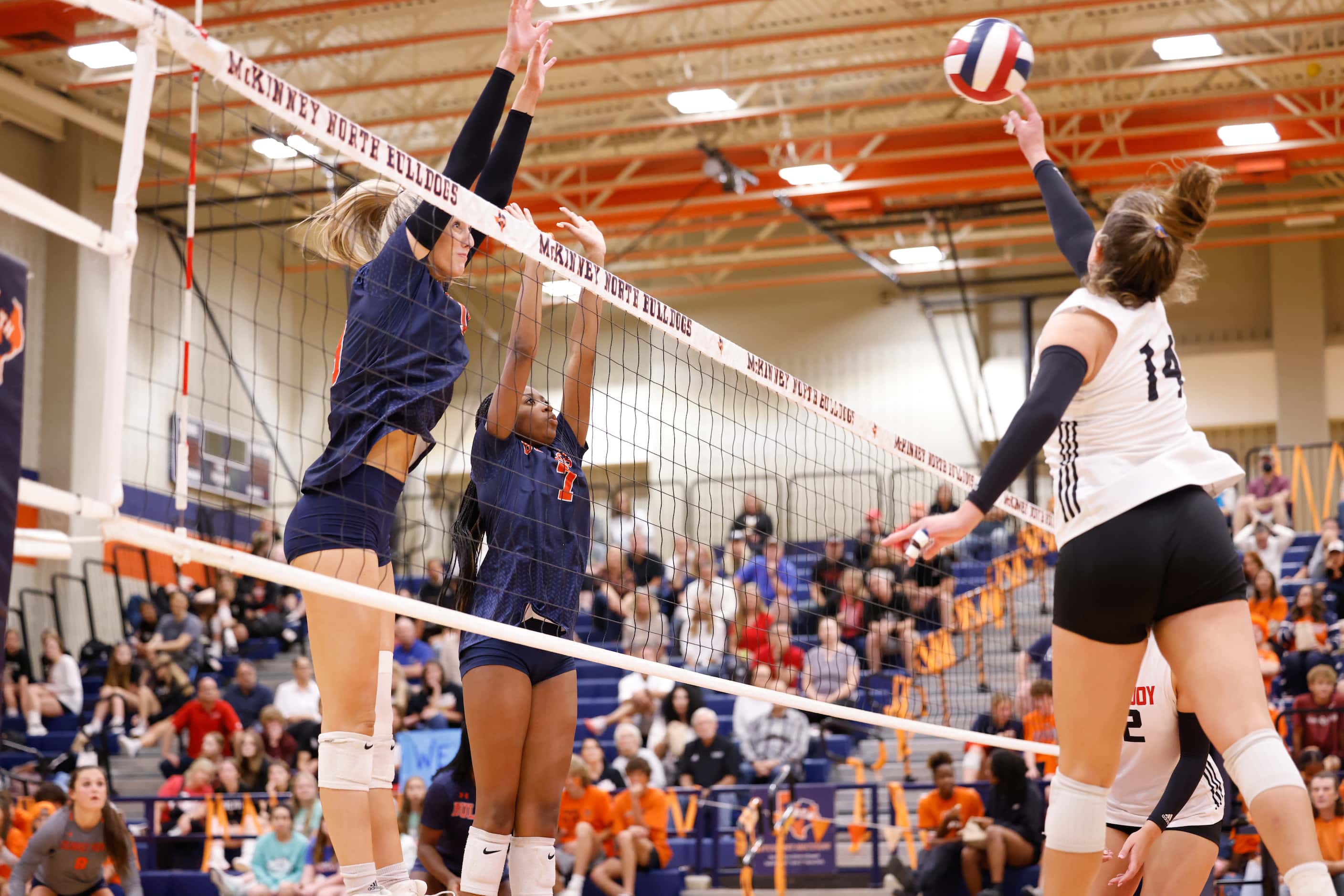 Lovejoy Charlotte Wilson (14) jumps to spike the into McKinney North defenders Natalie...
