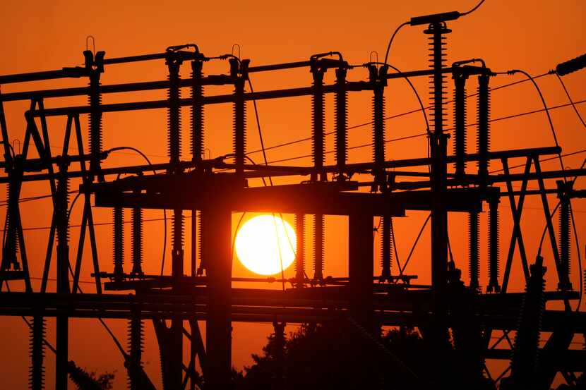 The sun sets through extreme humidity behind a Brazos Electric Power Cooperative substation...