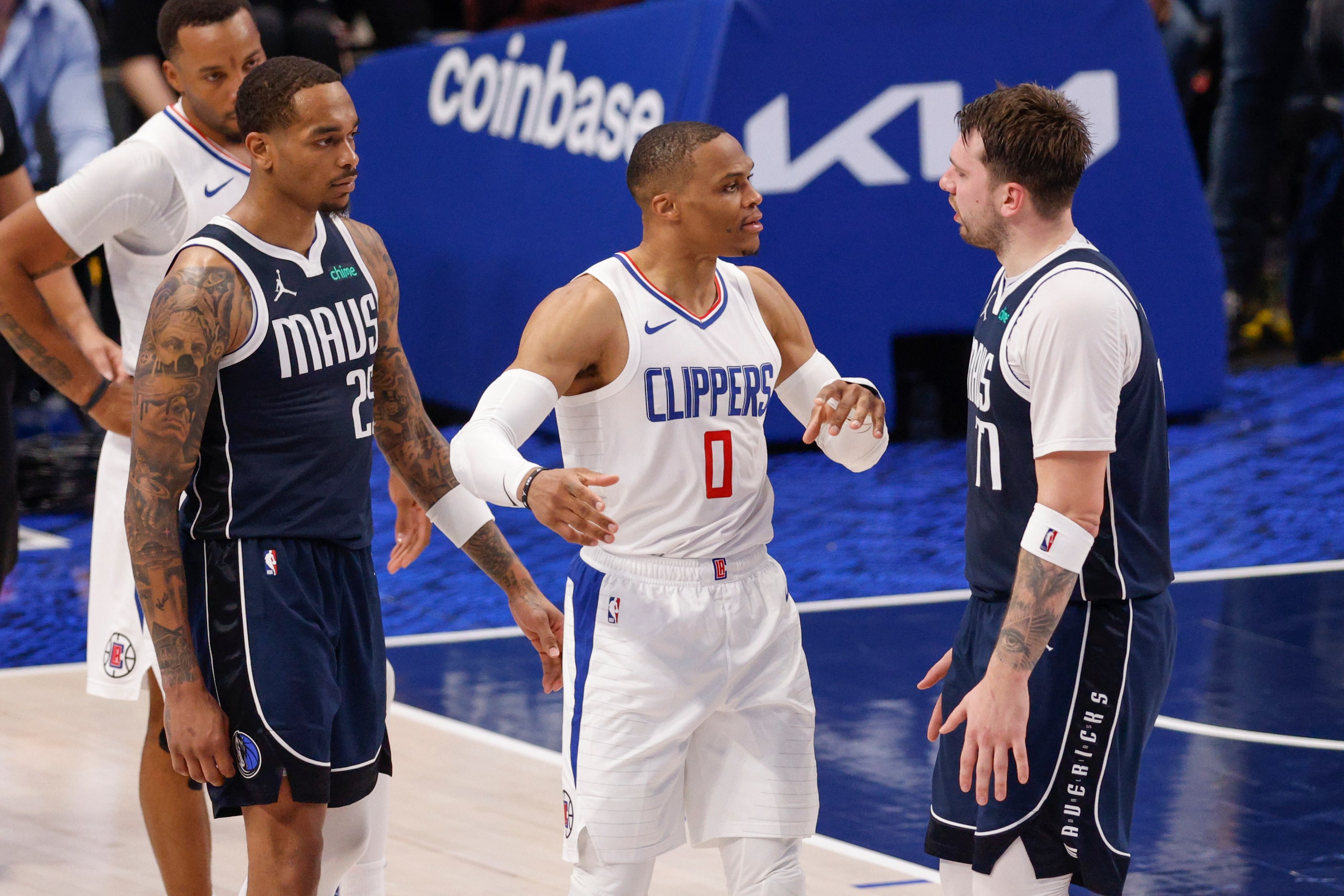 LA Clippers guard Russell Westbrook (0) and Dallas Mavericks guard Luka Doncic (77) argue...