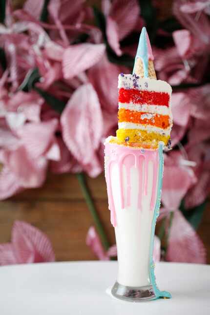 Here's the infamous unicorn milkshake, topped with a slice of cake.
