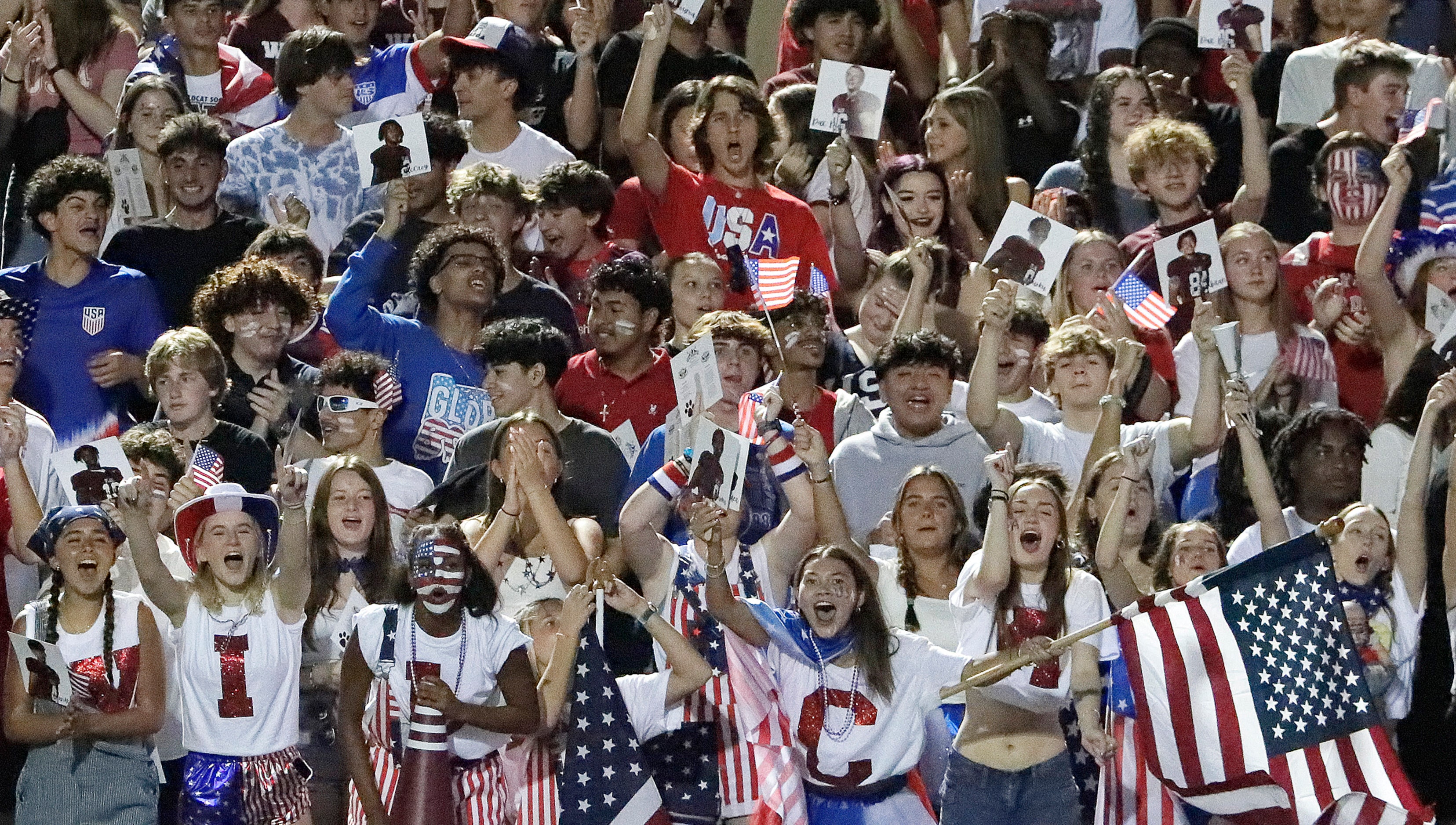 The Plano High School student section celebrates a touchdown during the first half as Plano...