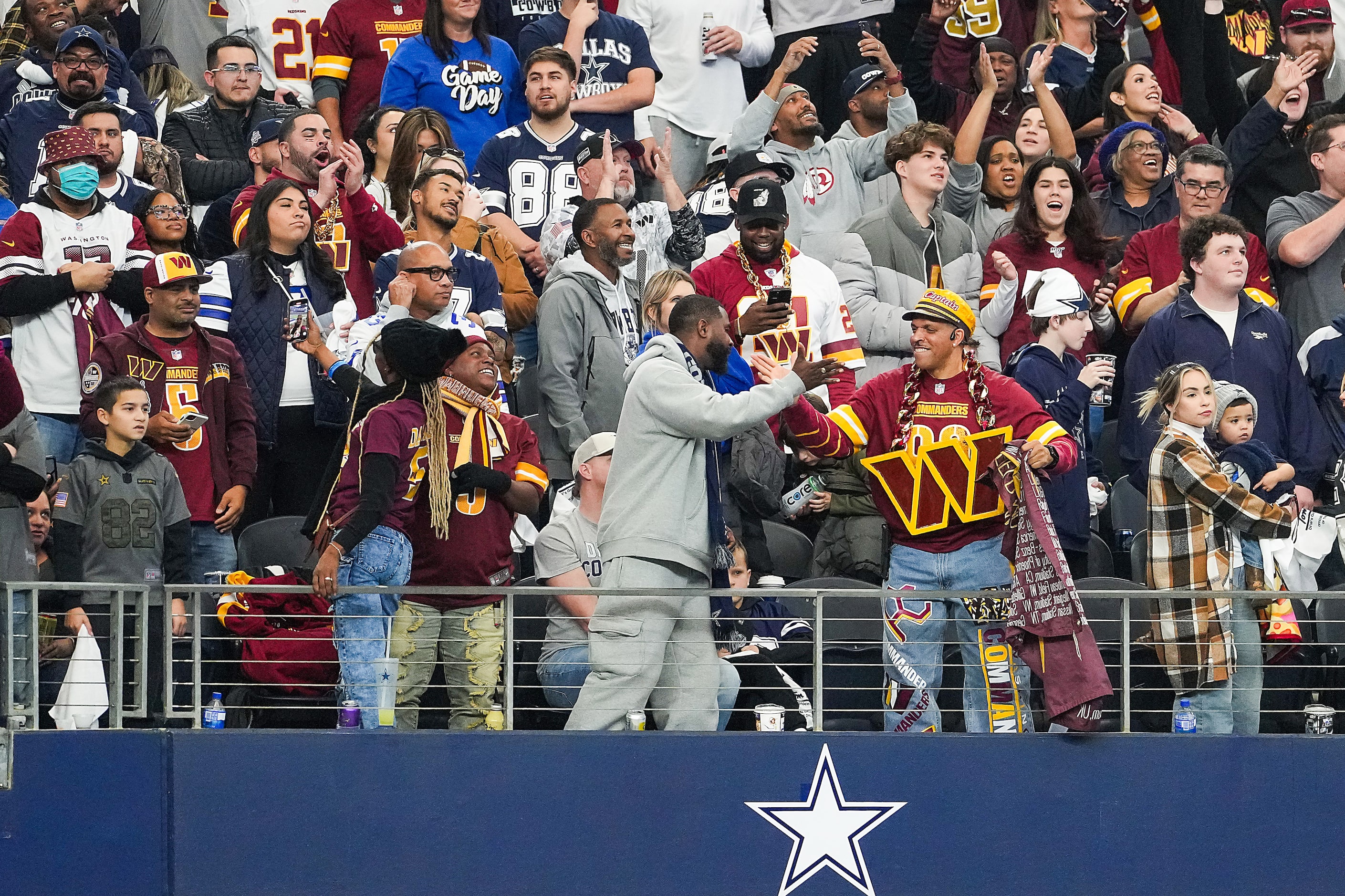 Washington Commanders fans celebrate a game-winning touchdown catch by Commanders wide...