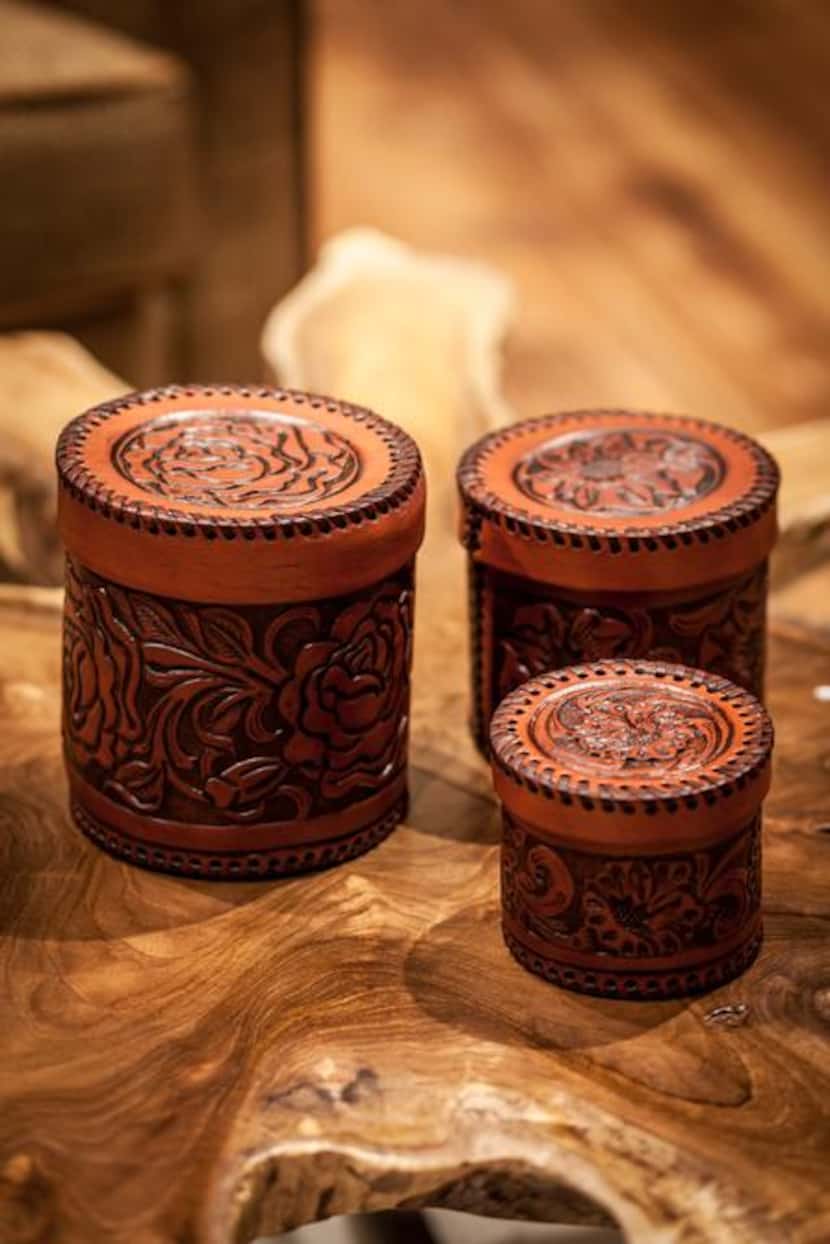 
Store those essentials in leather-tooled canisters. $129, set of three, at Antiques...