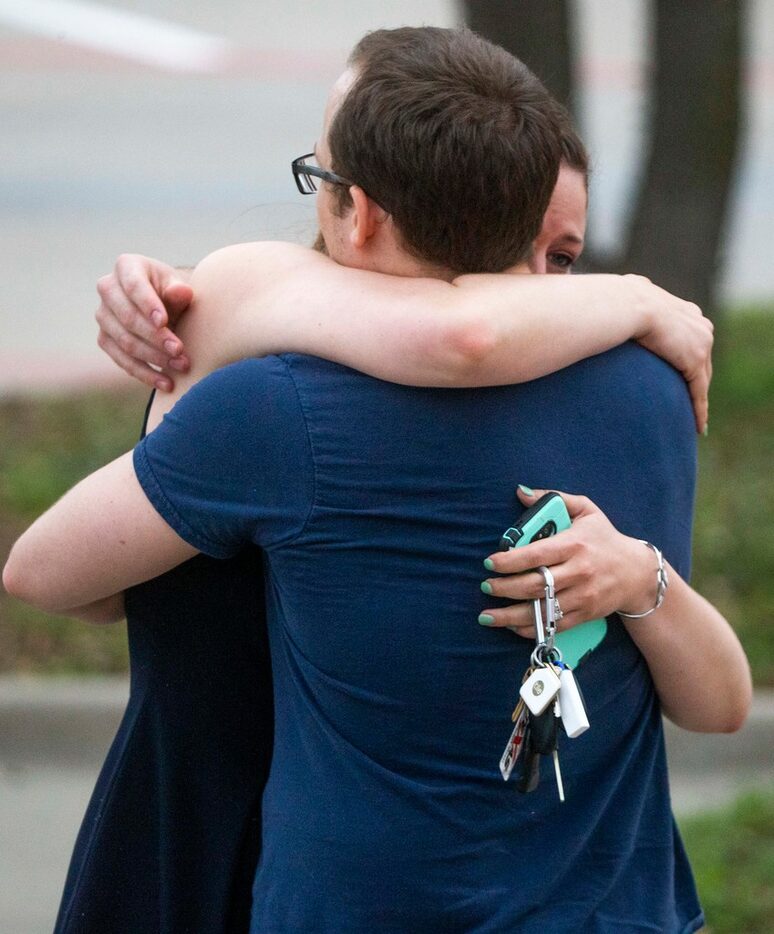 Scott Bowers embraces his fiancee Kimberly Wohled after his interview with the Texas Rangers...