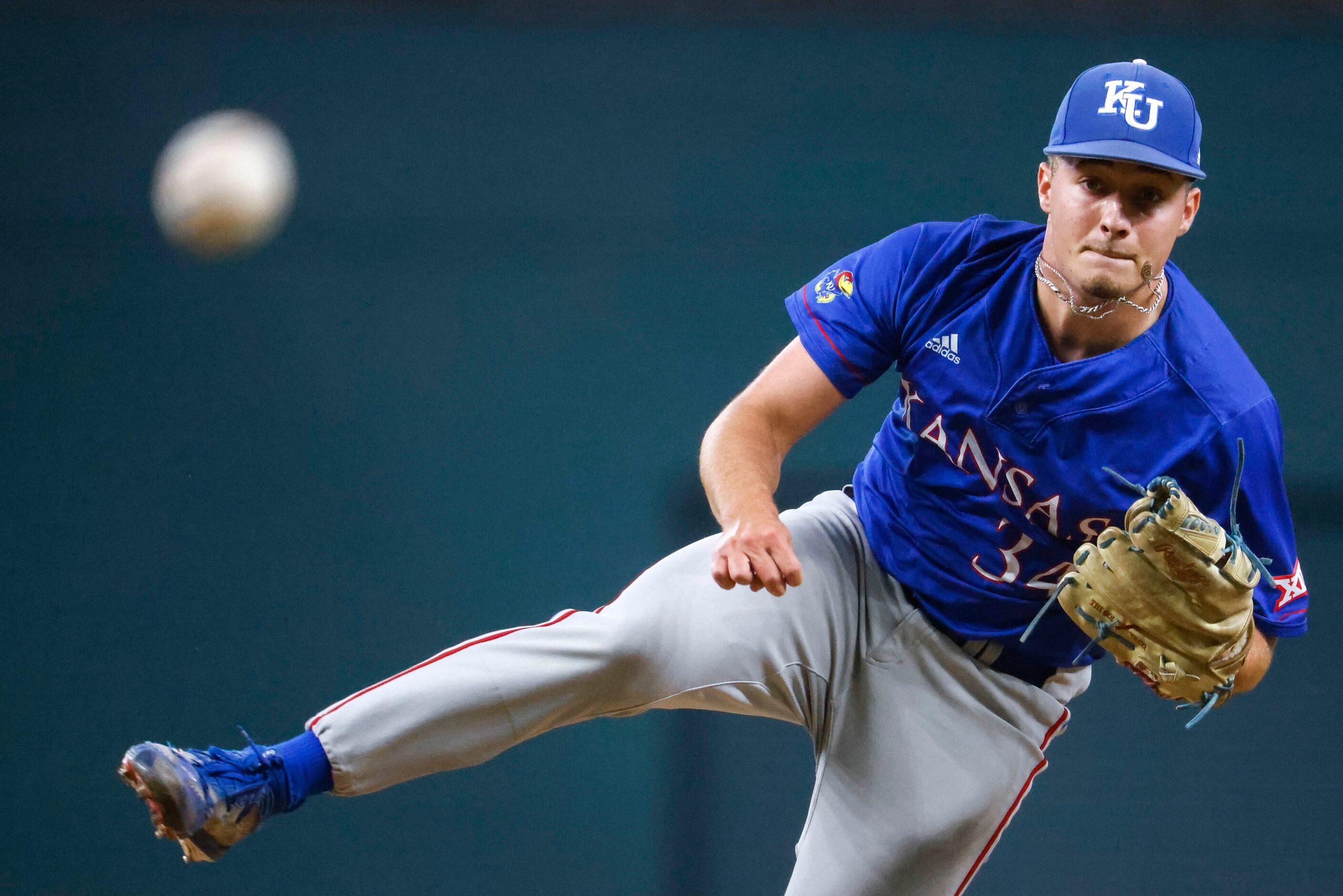 Kansas pitcher Kolby Dougan throws during the fourth inning of a baseball game against...