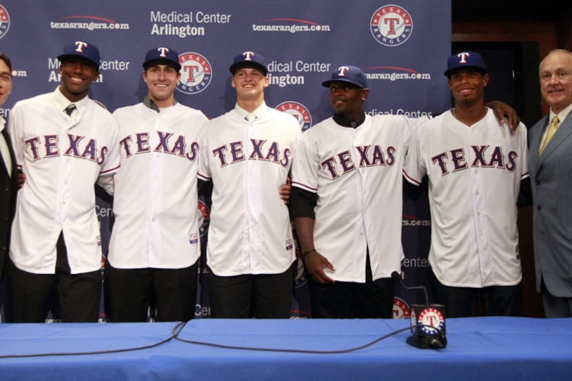 Texas Rangers General Manager Jon Daniels, left,  and president Nolan Ryan, right,  pose...