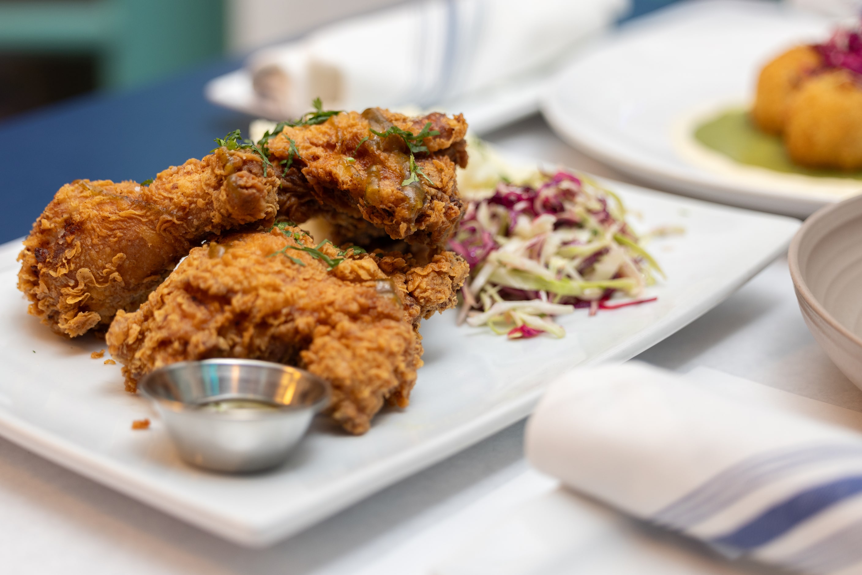 Crispy fried chicken with jalapeno glaze, garlic mash and pesca slaw is on the menu at Pesca...