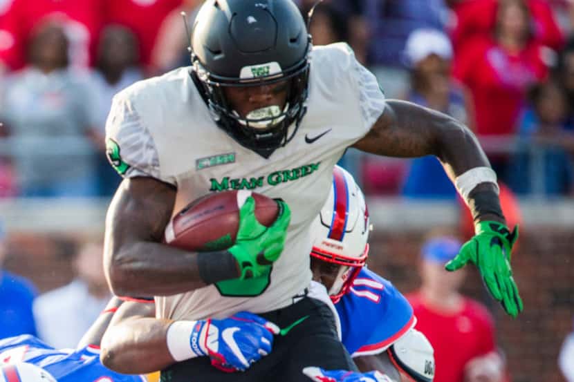 North Texas Mean Green running back Jeffery Wilson (3) is tackled by Southern Methodist...