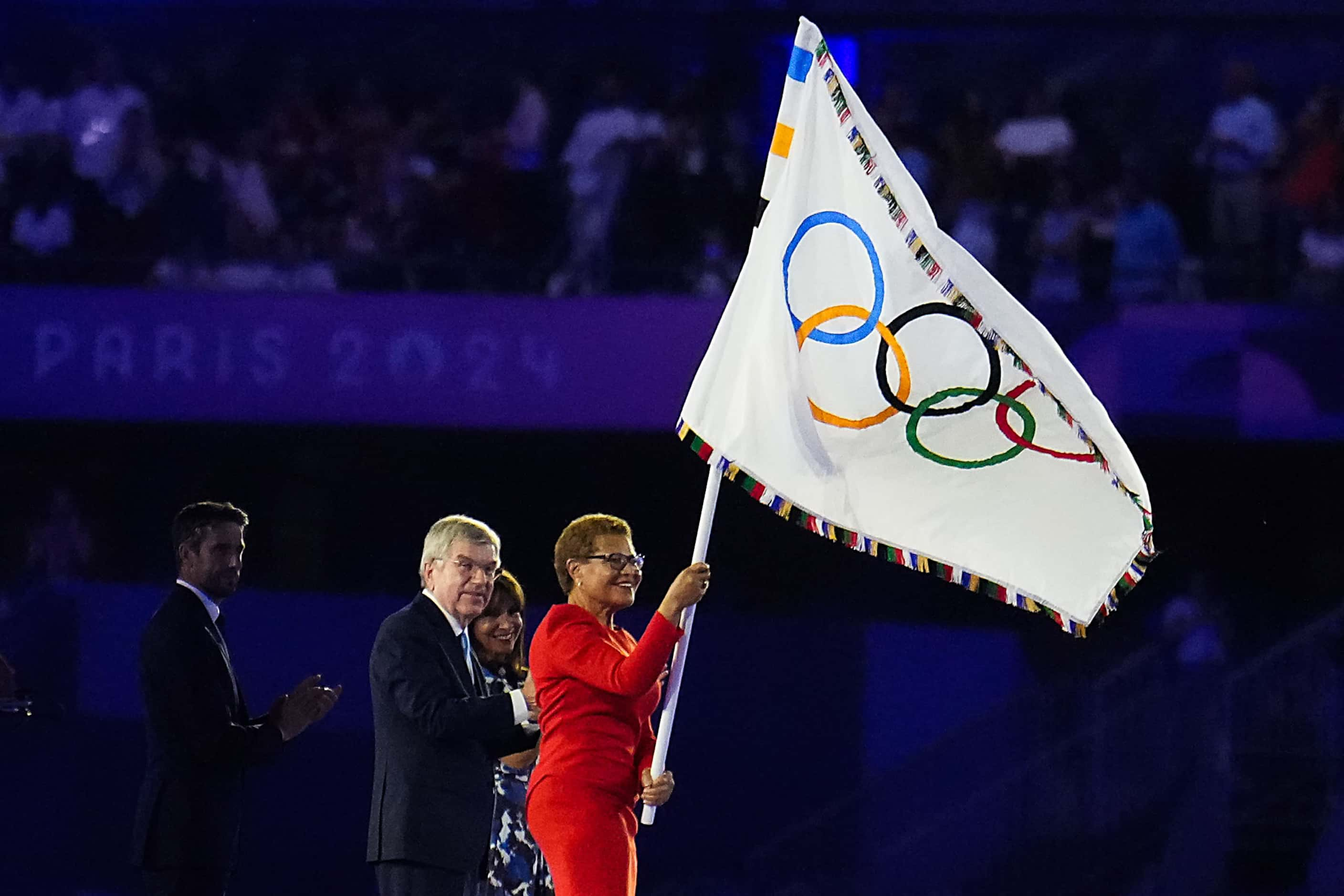 Los Angeles mayor Karen Bass waves the Olympic flag as part of the handover ceremony during...