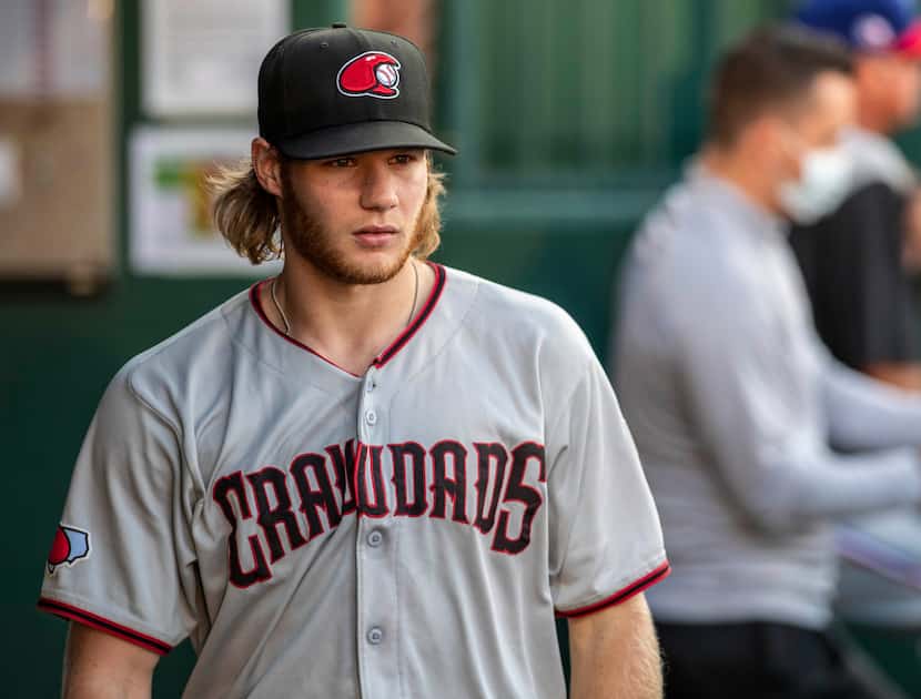 Hickory Crawdad's pitcher Zak Kent (11) walks in the dugout during the game with the...