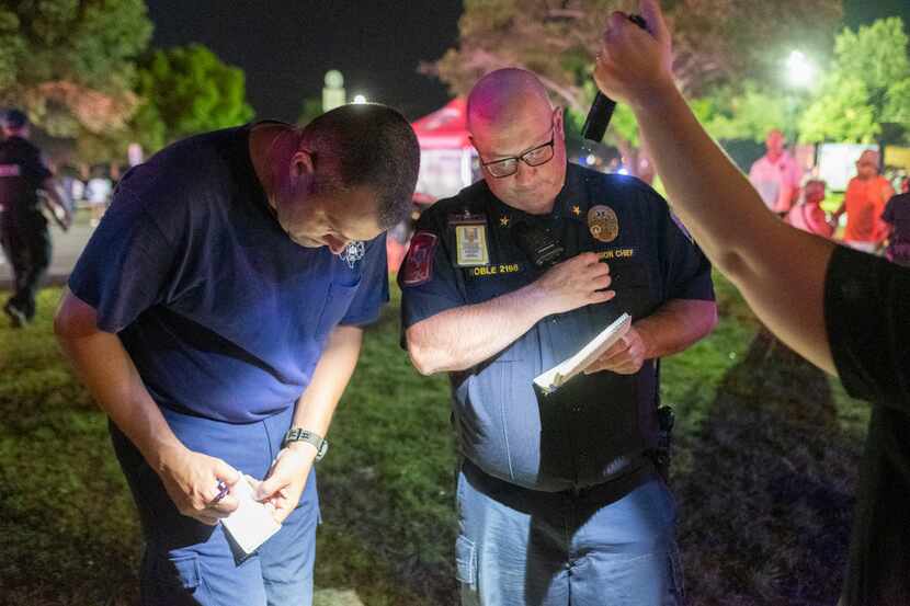 Austin County EMS Division Chief Keith Noble exchanges information with a member of the...