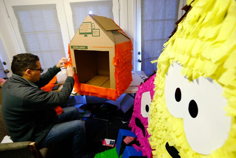 Valderas works on one of his 'Casitas Tristas' at his Oak Cliff home 