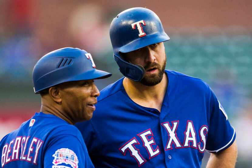 Texas Rangers center fielder Joey Gallo (13) chats with third base coach Tony Beasley (37)...