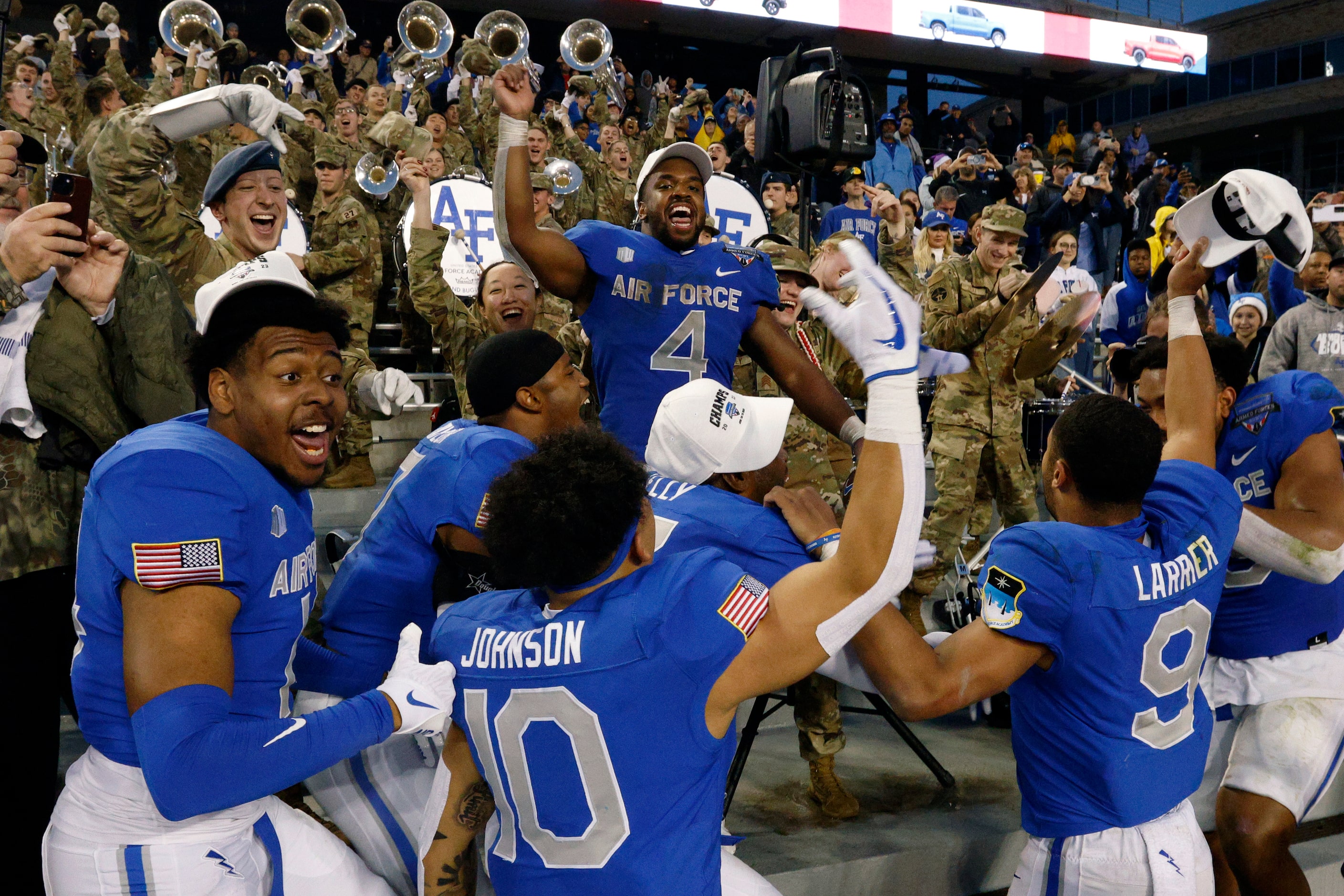 Air Force Falcons fullback Emmanuel Michel (4) celebrates with teammates and the band after...