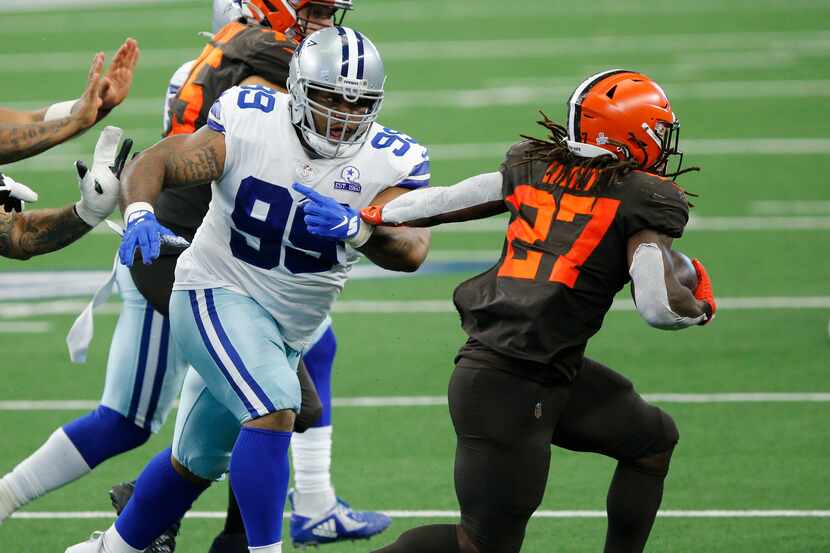 Dallas Cowboys defensive tackle Antwaun Woods (99) attempts to tackle Cleveland Browns...