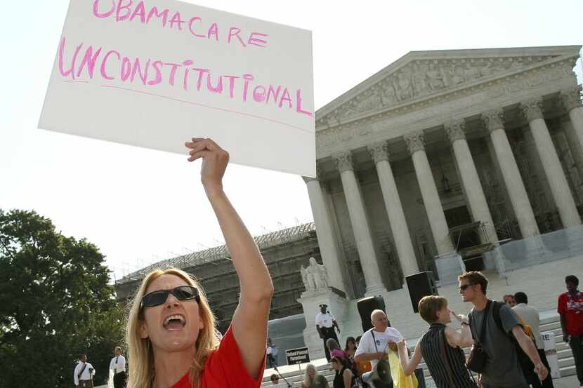 WASHINGTON, DC - JUNE 28: A woman protests against the Obama administrations health care...