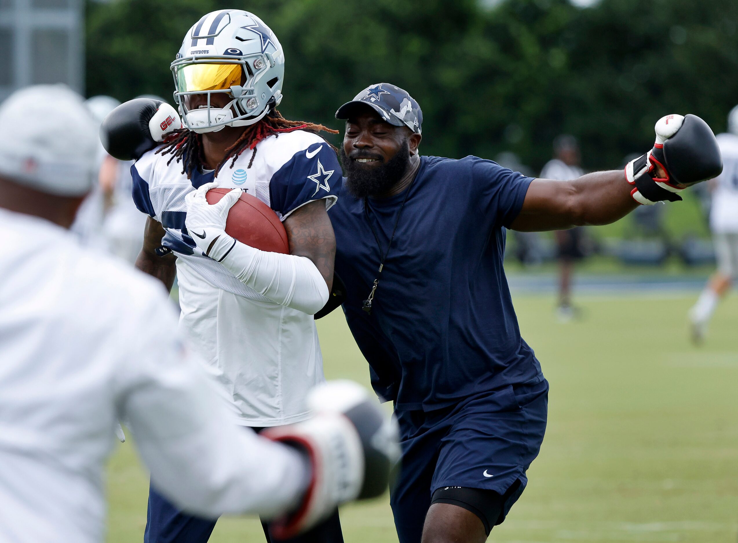 With his boxing gloves, Dallas Cowboys assistant strength and conditioning coach Kendall...