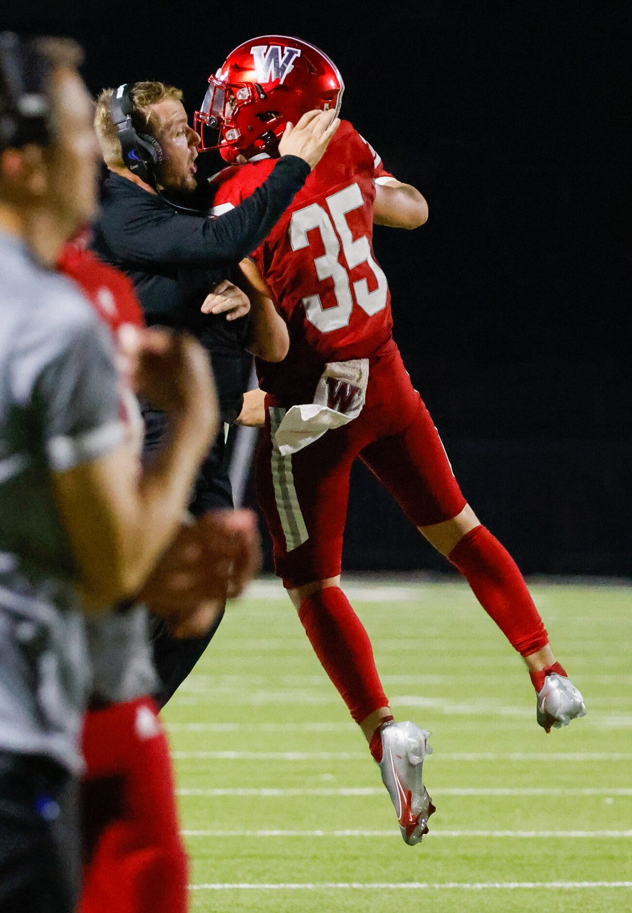 Woodrow Wilson head coach John Fish celebrates with line backer Reece McMillan (35) during...